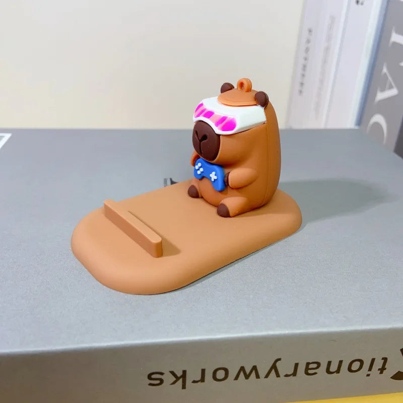 Diseño creativo de lindas figuras de capibara, soporte para teléfono de escritorio, soporte para persona perezosa, regalos decorativos creativos