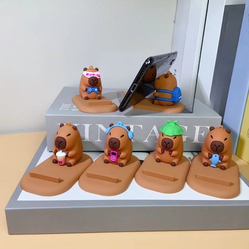 Diseño creativo de lindas figuras de capibara, soporte para teléfono de escritorio, soporte para persona perezosa, regalos decorativos creativos